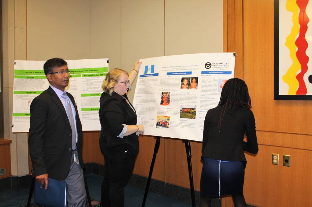 Image 1 of 15 People putting up their presentation posters, preparing for the showcase to begin